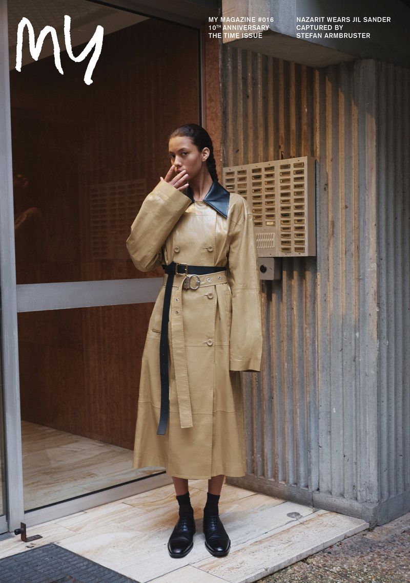 Model Nazarit Machin wearing a beige leather coat and black shoes outside a residential building captured by Stefan Armbruster