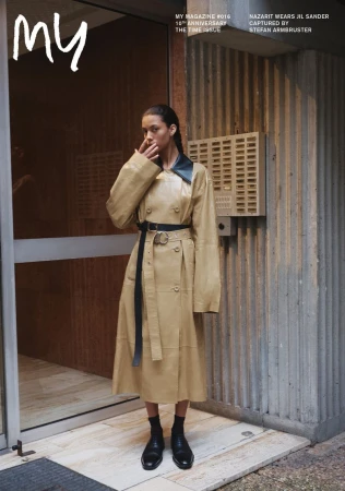 Model Nazarit Machin wearing a beige leather coat and black shoes outside a residential building captured by Stefan Armbruster
