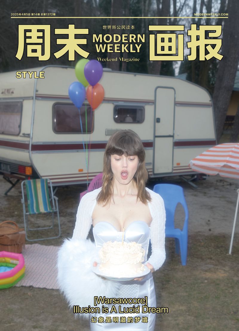 Magazine cover featuring a woman in a white dress holding a cake, with a caravan and balloons in the background.