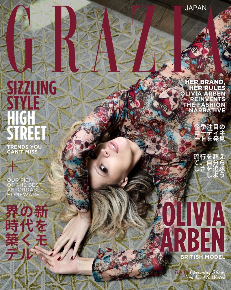 Fashion magazine cover featuring Olivia Arben, a British model, wearing a floral print dress and lying on a patterned carpet.