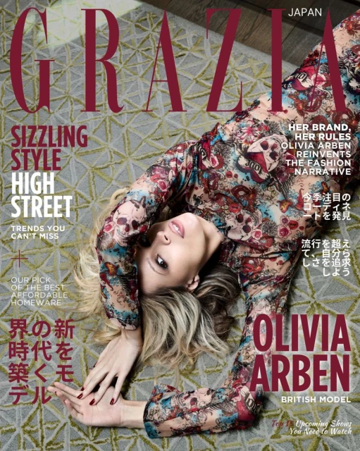 Fashion magazine cover featuring Olivia Arben, a British model, wearing a floral print dress and lying on a patterned carpet.