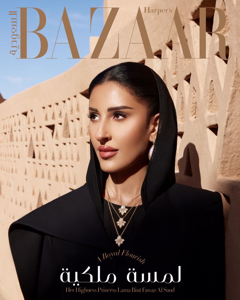 Magazine cover of Harper's Bazaar featuring woman in traditional black dress, jewelry, and head covering standing in front of stone building.