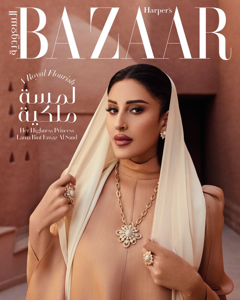 Fashion magazine cover featuring a woman in a neutral dress and headscarf, adorned with pearl jewelry, against a textured backdrop.