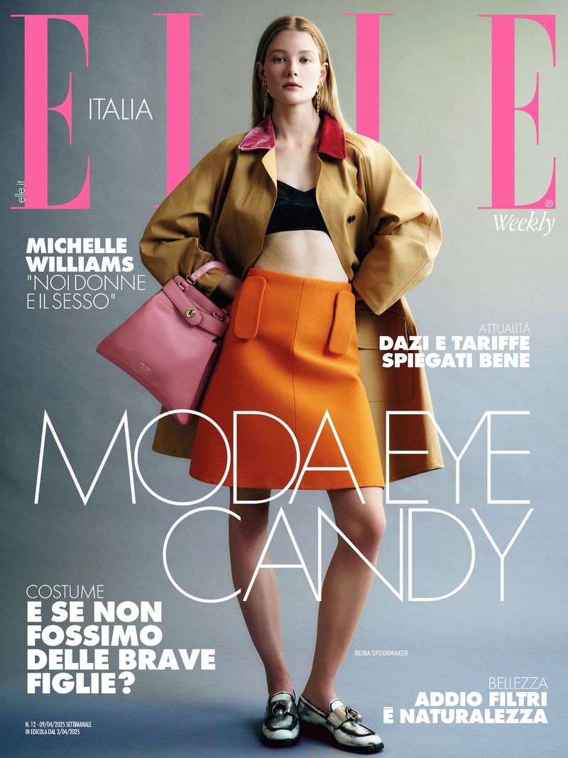 Elle Italia magazine cover features a female model in a tan coat, orange skirt, and black top holding a pink purse against a grey backdrop.