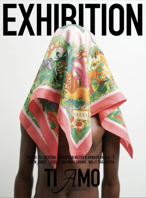 Exhibition ad featuring a dark-skinned male model wearing a Gucci scarf with animal and foliage designs, set against a stark white backdrop.