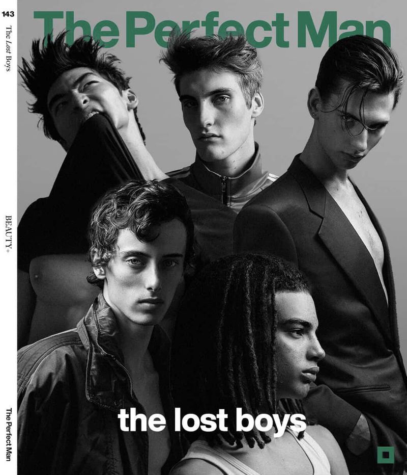 Black and white portrait of five male models posing together for The Perfect Man Magazine against a grey background.