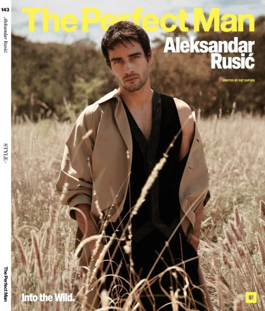 Magazine cover featuring a man in a tan coat standing in a field of tall grass, with magazine text and titles overlaid.