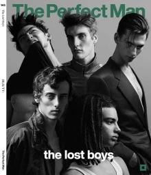 Black and white portrait of five male models posing together for The Perfect Man Magazine against a grey background.