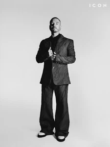 J Balvin standing in a patterned suit against a white studio background for ICON Magazine Mena, photographed by Isaac Anthony.