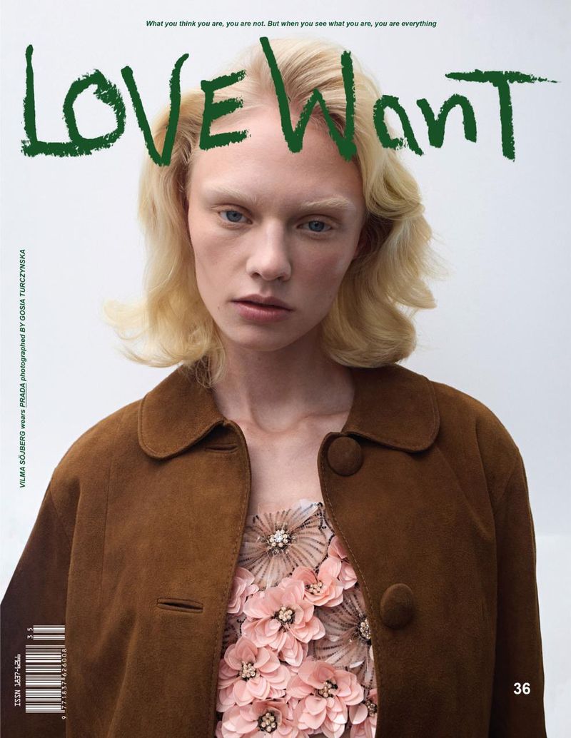 A model poses wearing a floral dress with a brown jacket in a portrait-style fashion magazine cover with green text against a white background.