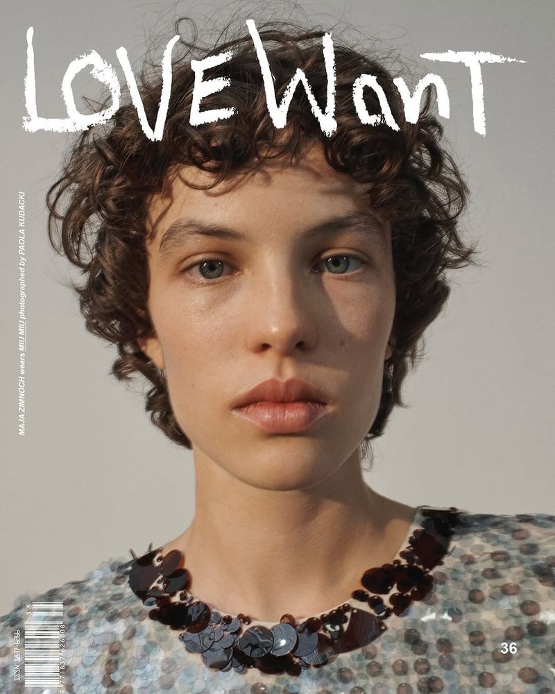 Close-up portrait of a curly-haired young woman wearing a sequined top against a plain background, as seen on a magazine cover.