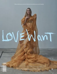 Model Liisa Winkler wearing a draped amber gown in a magazine cover portrait against a grey studio wall