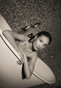 Woman leaning on a bathtub in a tiled bathroom setting for InStyle Greece Party Animal editorial by Dominika Witos
