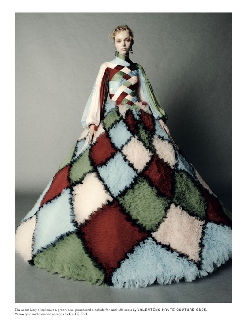 Fashion model in Valentino Haute Couture dress with red, green, blue, and peach chiffon and tulle in studio setting, full shot.
