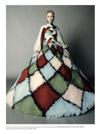 Fashion model in Valentino Haute Couture dress with red, green, blue, and peach chiffon and tulle in studio setting, full shot.