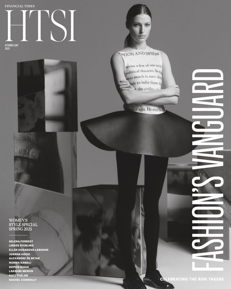 Black-and-white fashion editorial cover featuring a woman in a couture outfit with a text-covered top and a wide skirt, alongside text elements.