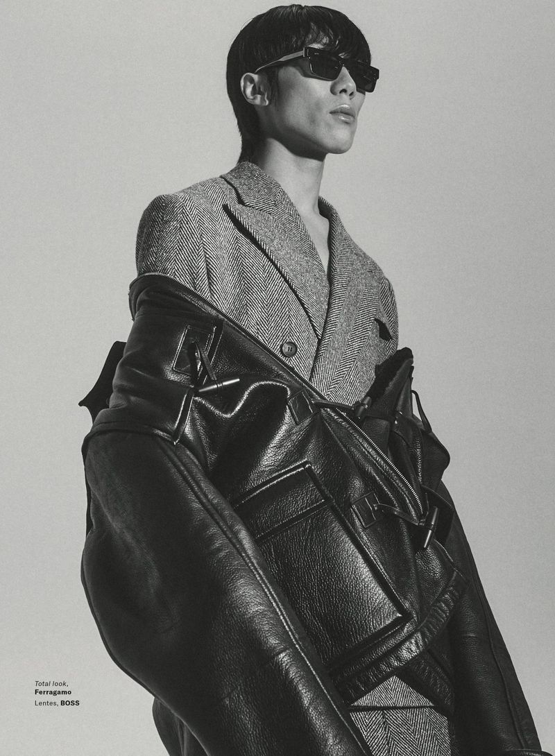 Man wearing dark sunglasses and a houndstooth blazer with a black leather jacket for GQ Mexico editorial.