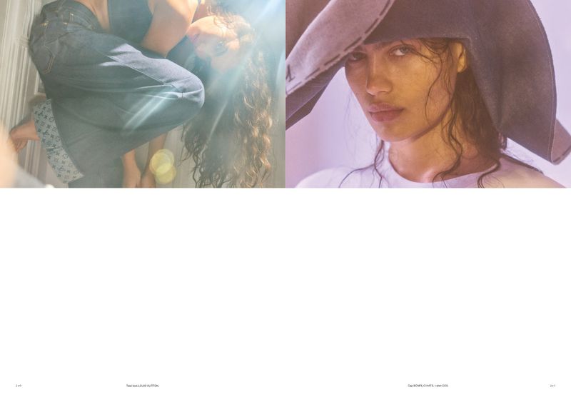 Two women posing: one with long curly hair in jeans and the other in a hat and white top with a soft, diffused light setting.