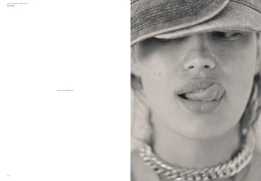 Close-up portrait of Alana Felisberto wearing a denim cap and chunky silver chain necklace for Mia Le Journal.