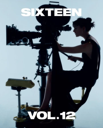 Woman in black dress operates vintage camera against soft white background. Focus on camera and operator in photo studio setting.