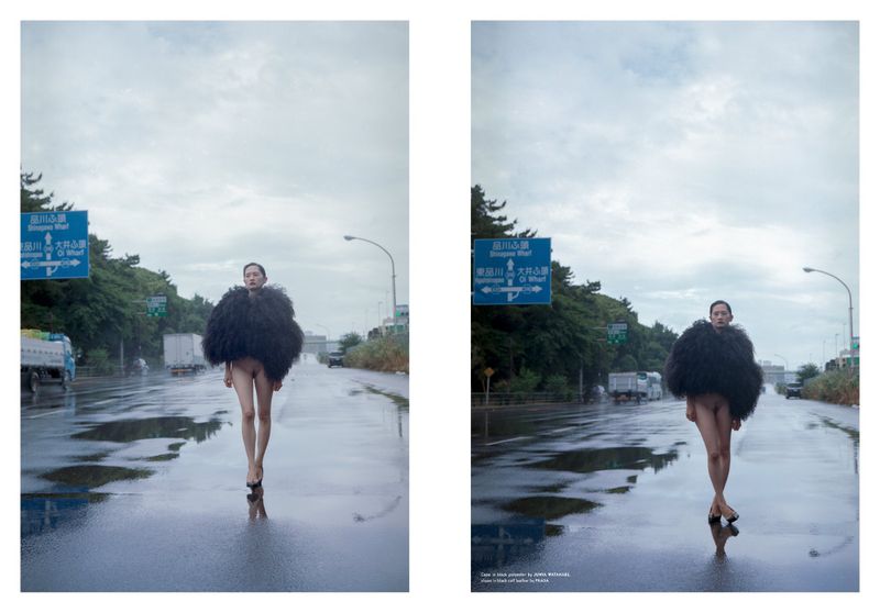 A striking image featuring a model in a dark, voluminous feather coat confidently walking down a wet road under an overcast sky.