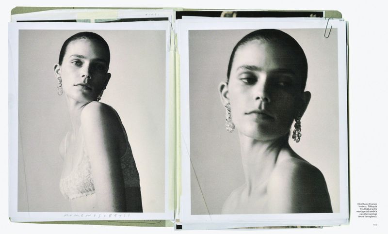 Black and white portraits of a woman wearing ornate earrings are displayed side-by-side in an open magazine or portfolio.