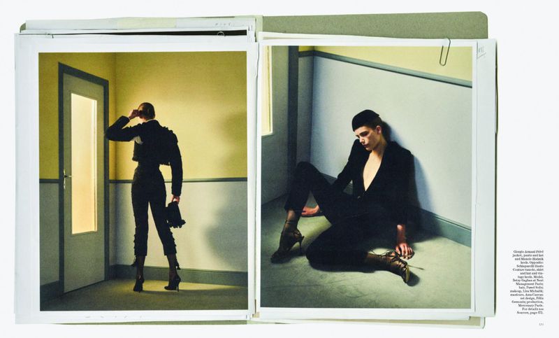 Fashion editorial photo spread in book featuring model wearing black jacket and pants in yellow room, plus man in black suit.