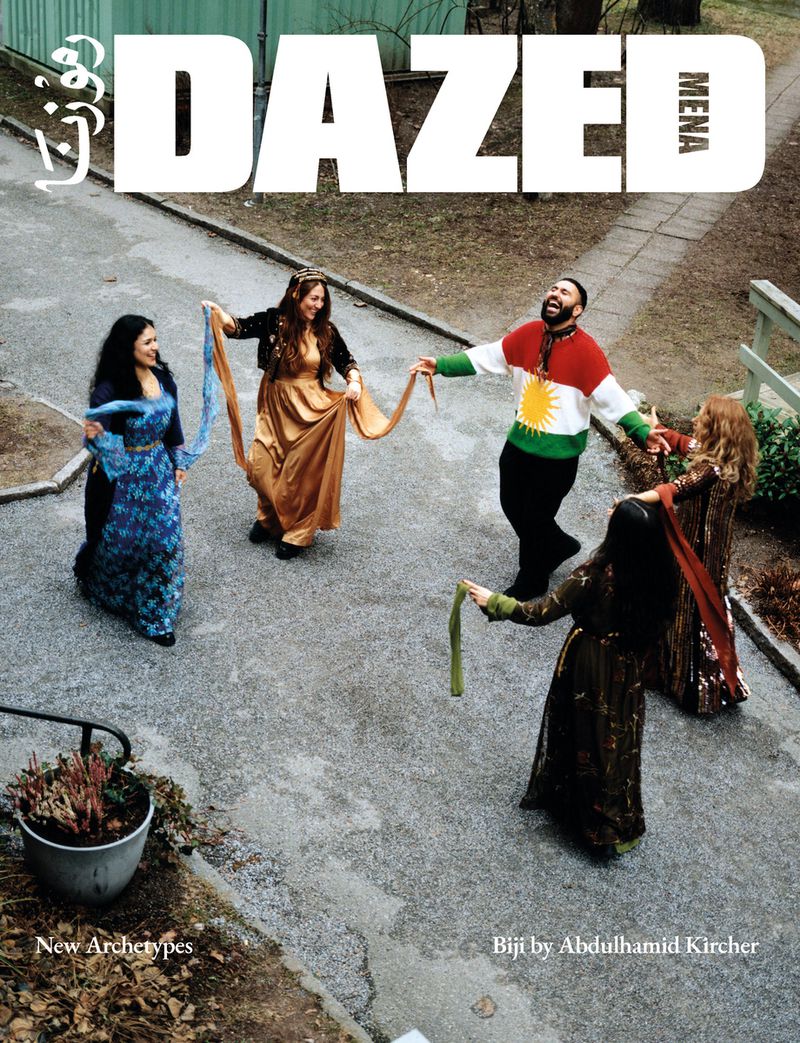 Magazine cover featuring a group of people in a circle in a courtyard, wearing colorful, traditional clothing, with DAZED magazine logo at the top.