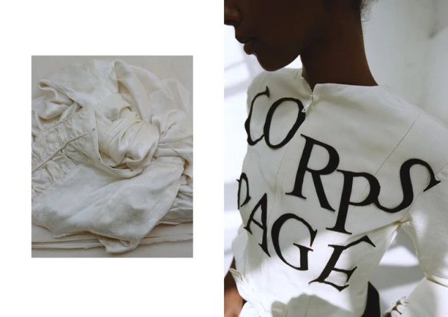 Fashion shot of a black model wearing an avant-garde white dress with black graphic text. The shot highlights unique design and styling.