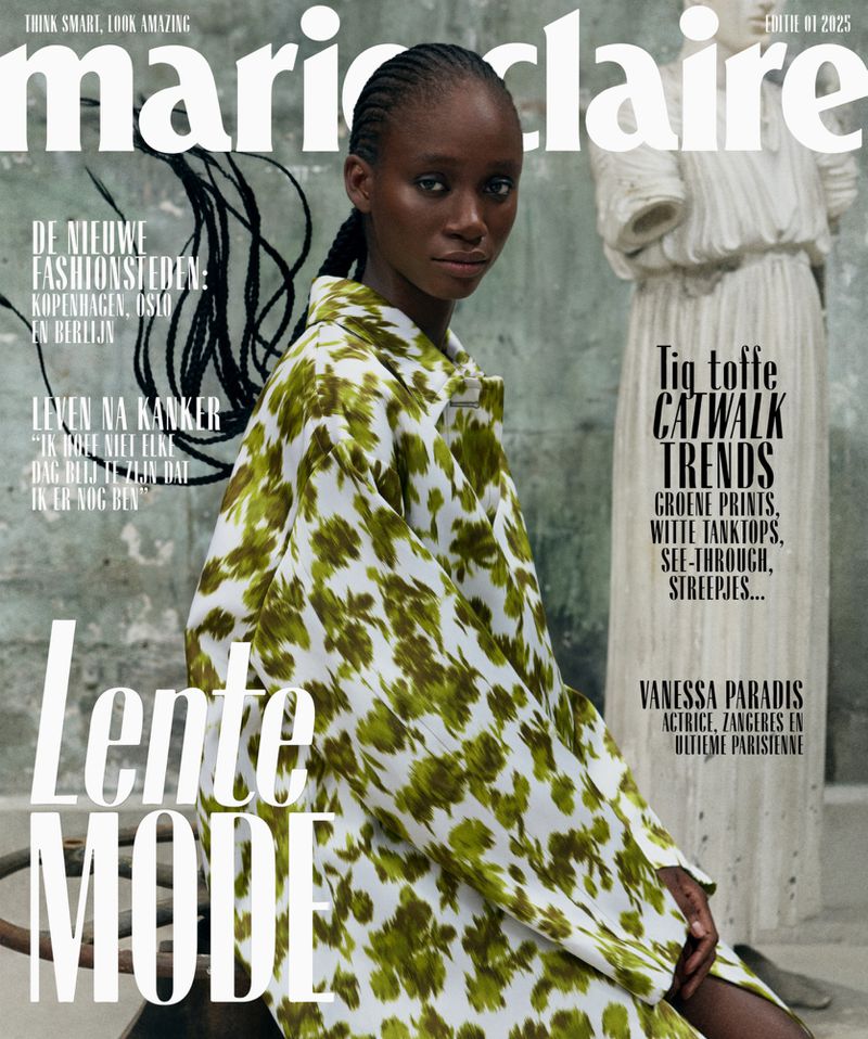 Marie Claire magazine cover featuring an African-American female model wearing a floral print jacket, with a classical statue in the background.