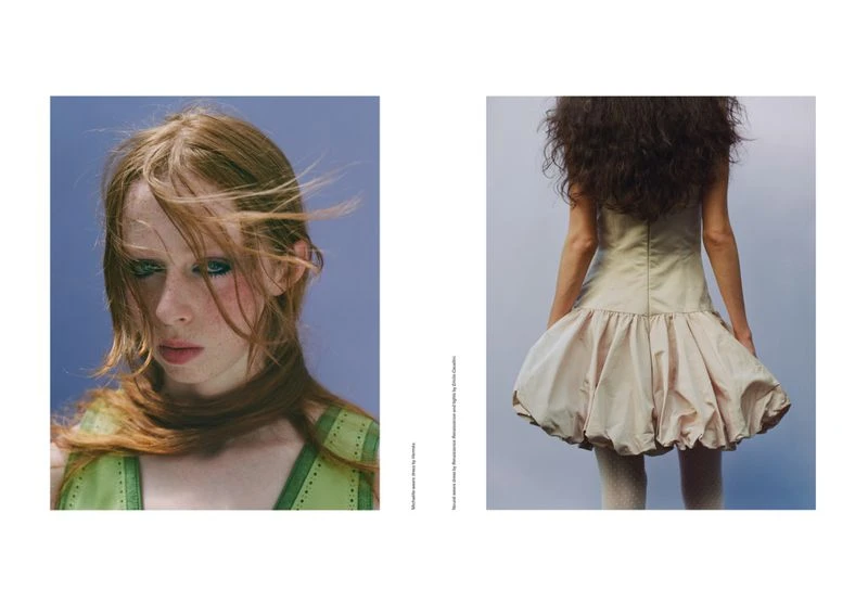 Fashion editorial shot featuring a red-haired woman in green dress and a woman with dark curly hair in a beige dress.
