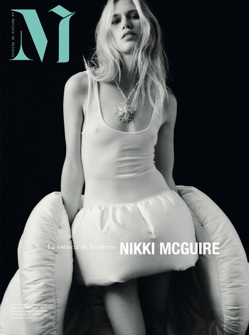 Magazine cover featuring a young female fashion model with long blonde hair wearing a white outfit, set against a black background.