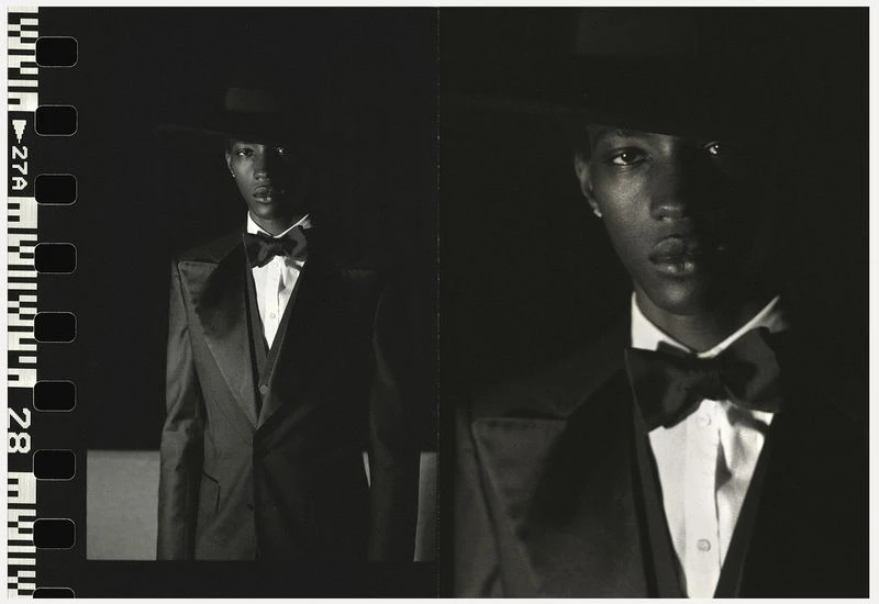 Monochrome portrait of an African American male in a dark suit, bow tie and hat. Filmstrip border on the left adds an artistic touch.