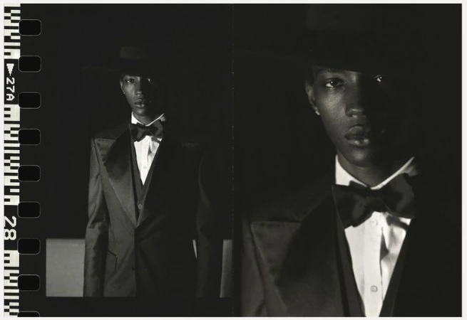 Monochrome portrait of an African American male in a dark suit, bow tie and hat. Filmstrip border on the left adds an artistic touch.