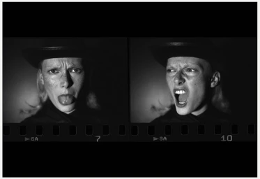 Black and white contact sheet frames showing a model in a dark hat making expressive faces against a dark background.