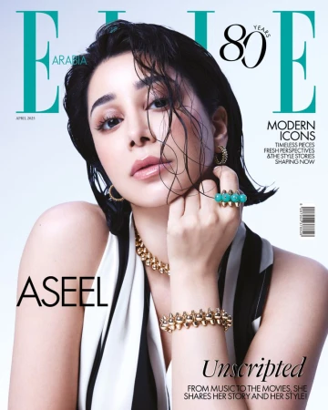 Elle Arabia magazine cover featuring a portrait of Aseel Omran wearing gold jewelry and a black and white outfit against a white backdrop.