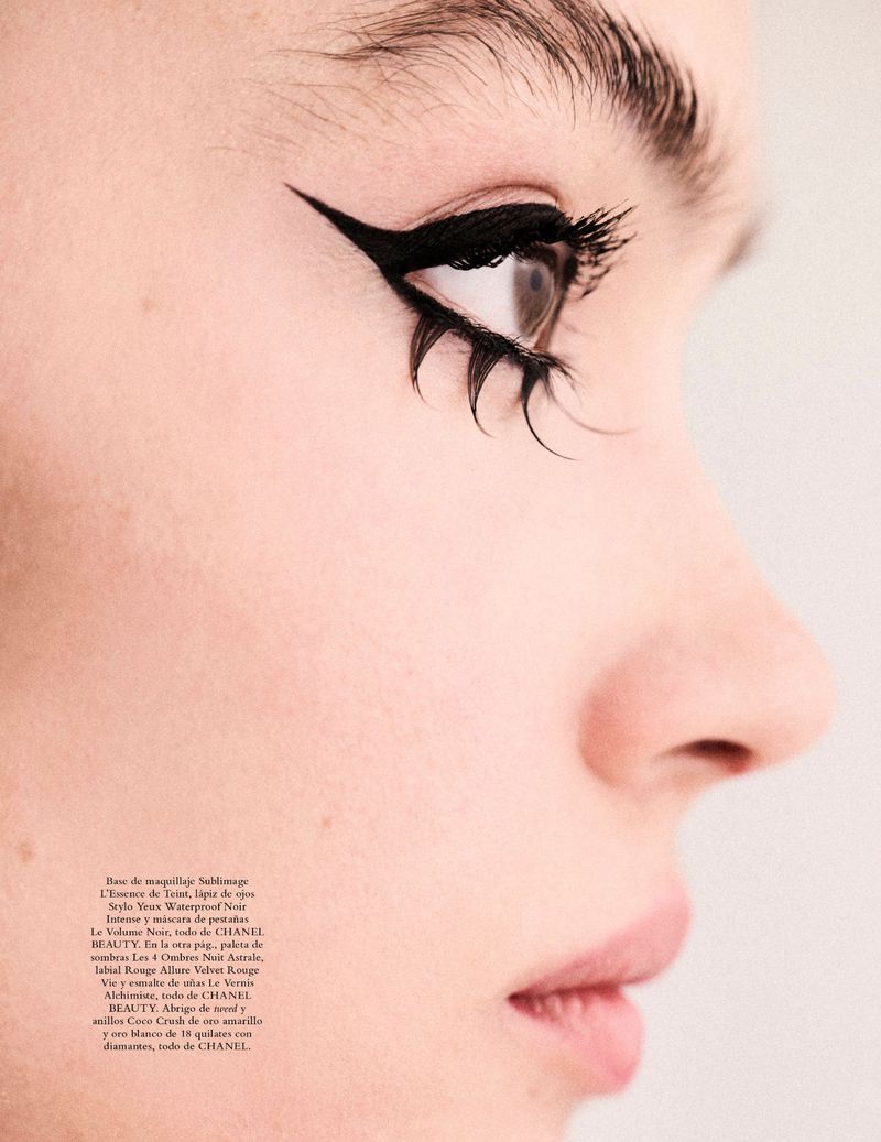 Close-up studio shot of a woman's face featuring dramatic black winged eyeliner and exaggerated individual lash extensions.