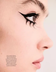 Close-up profile of model Sasha Kichigina featuring bold graphic black winged eyeliner and spiked lower eyelashes.