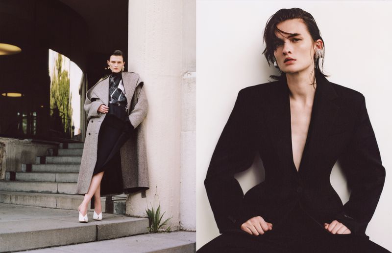 Two fashion models pose outdoors: one woman in a coat and heels on steps, and another in a black jacket against a white wall.