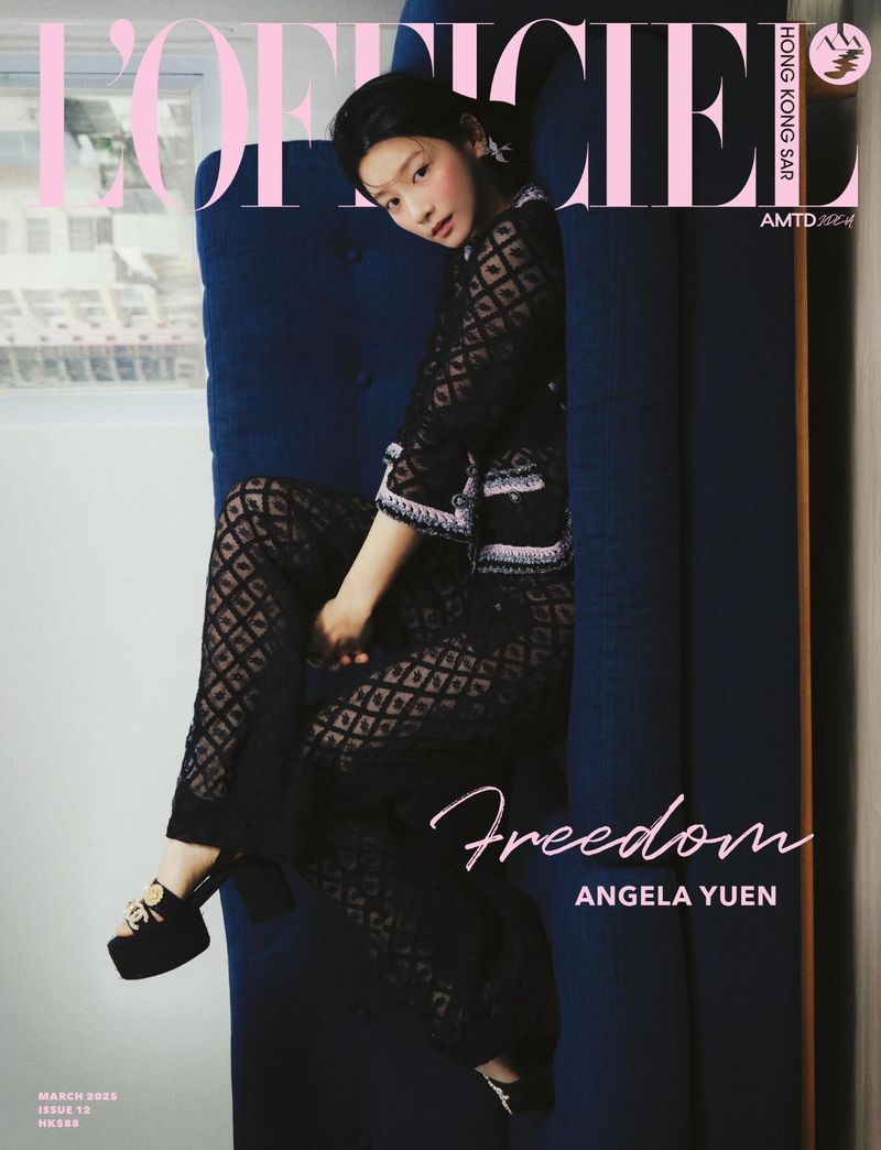 Magazine cover featuring an Asian woman with dark hair and black patterned attire sitting on a blue cushion, captured indoors.