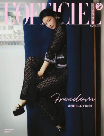 Magazine cover featuring Angela Yuen seated against a tall blue tufted velvet headboard wearing a patterned black lace outfit.