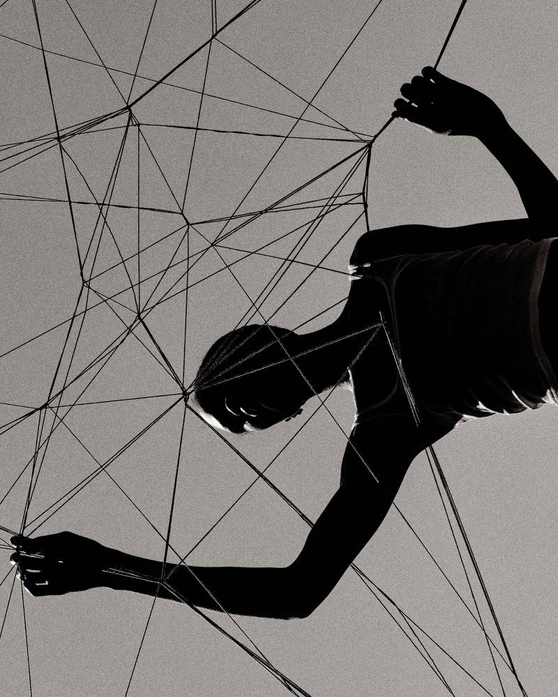 Silhouette of person surrounded by tangled thin black string against light gray background. Abstract composition. Minimalist art.