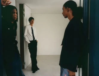 Three male models in an interior setting wearing dark clothing and a white shirt with tie for Cero Magazine