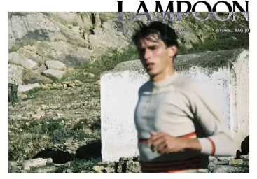 Model Clement Laguardia running in a striped cream knit sweater past a white concrete structure in a rocky rural landscape.