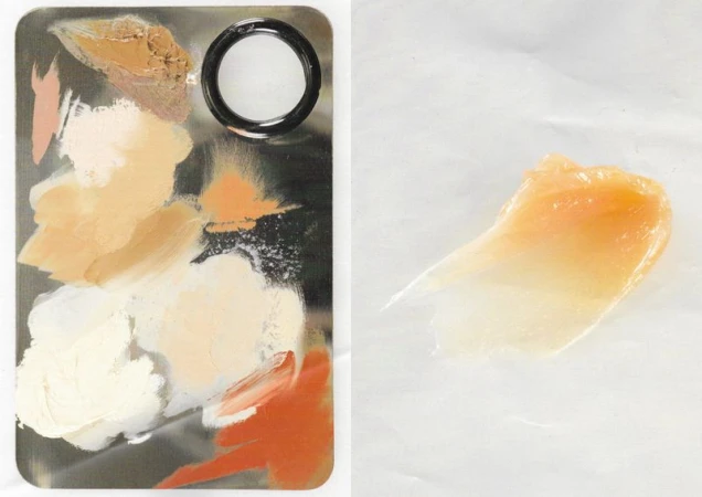 Cosmetic palette with foundation shades and swatch of cream highlighter on white background. Beauty product presentation, neutral tones.