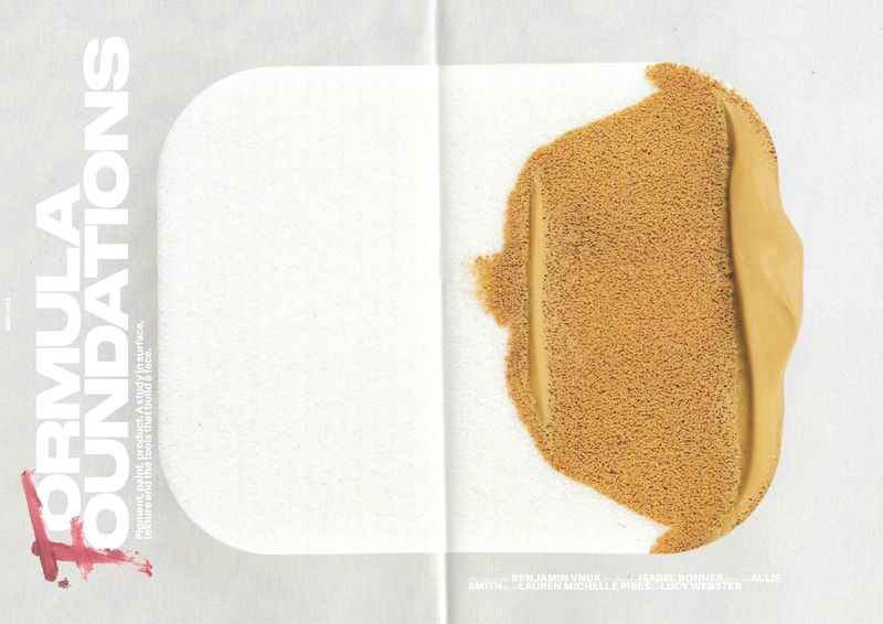 Close-up of bronze-toned cosmetic foundation makeup swatches on a white surface, next to a magazine page with cosmetic product details.