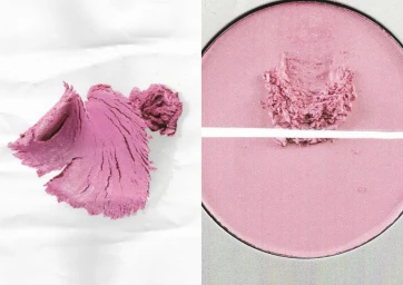 A textured pink cosmetic swatch with ridges alongside a round compact pan of crushed rose blush powder.