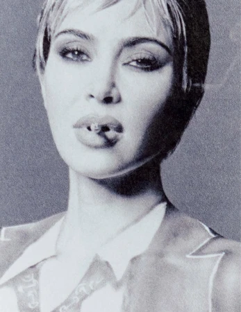 Close-up portrait of Kim Kardashian with short hair and a cigarette in her mouth, shot in monochrome grain for Re-Edition Magazine.
