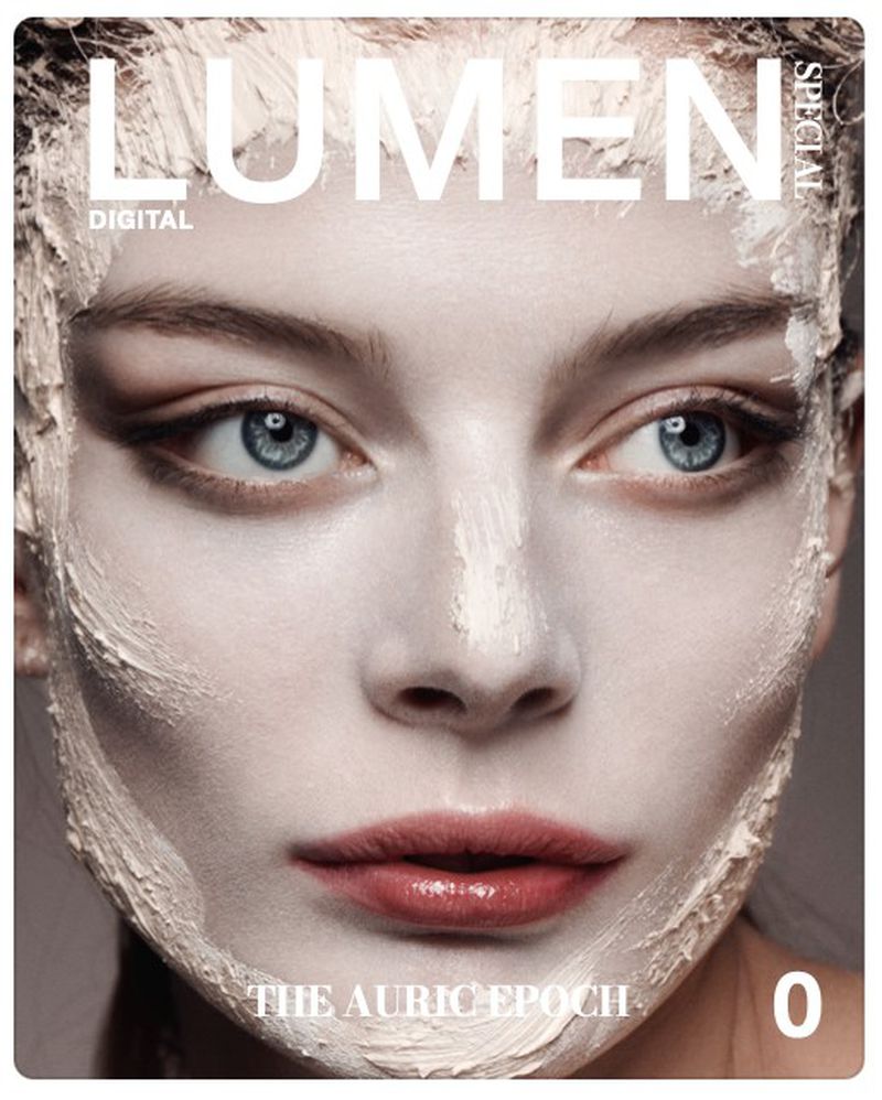 Close-up portrait of a woman's face with a white facial mask, bright blue eyes, and a magazine cover aesthetic, beauty focused.