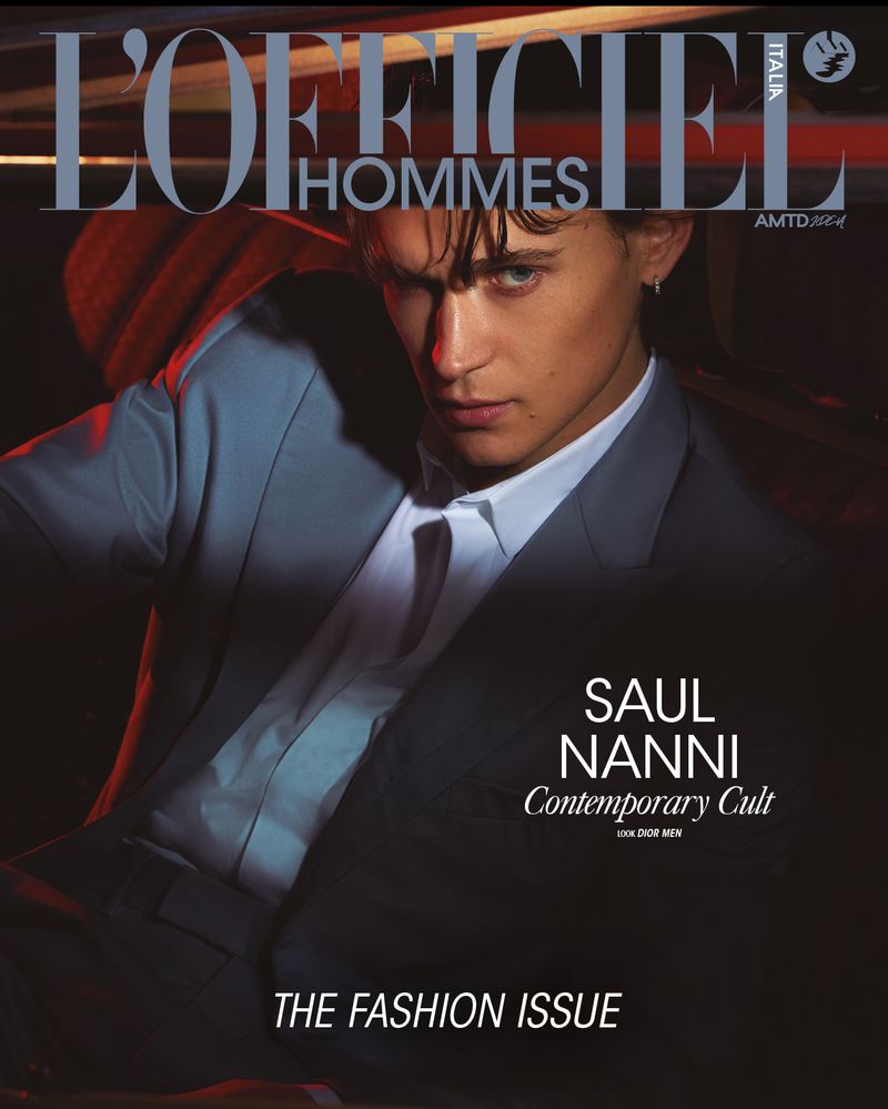 Magazine cover featuring a young adult male model in a grey suit and white shirt, with text 'L'OFFICIEL HOMMES' and 'SAUL NANNI'.